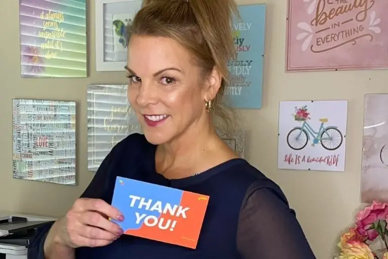 angie strader holding a thank you card