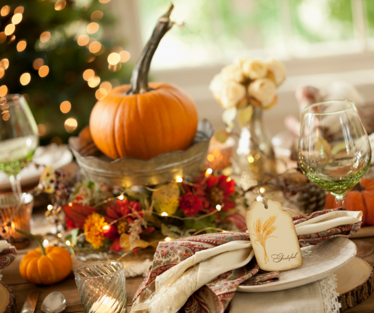 Table set with Thanksgiving decorations and a beautiful pumpkin centerpiece